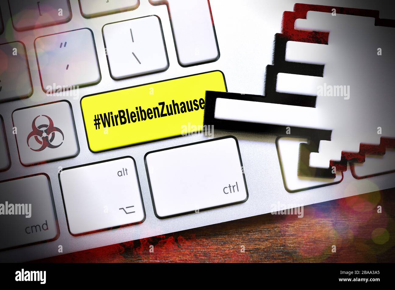 PHOTOMONTAGE, computer key with the Hashtag #WirBleibenZuhause and biology danger sign, FOTOMONTAGE, Computertaste mit dem Hashtag #WirBleibenZuhause Stock Photo