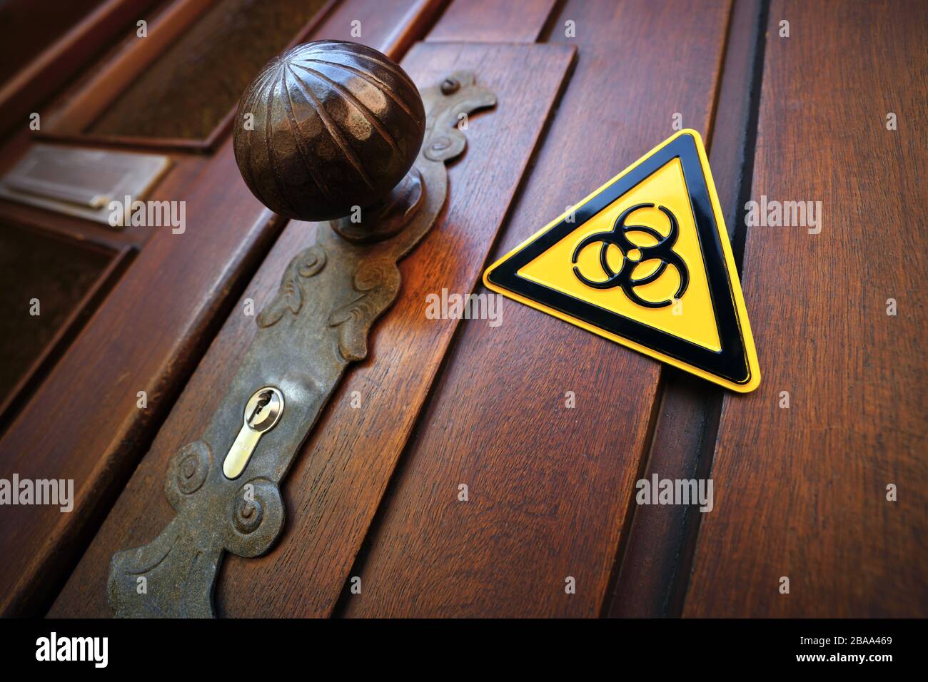 Biology danger sign in a front door, symbolic photo for domestic quarantine, Biogefährdungsschild an einer Haustür, Symbolfoto für häusliche Quarantän Stock Photo