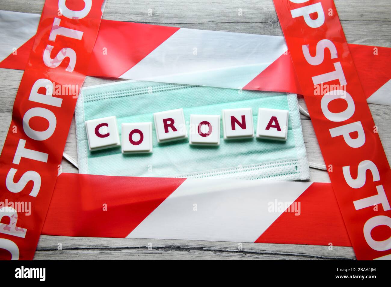 Corona stroke on mask and stop tape, symbolic photo Coronavirus, Corona-Schriftzug auf Mundschutz und Absperrband, Symbolfoto Coronavirus Stock Photo