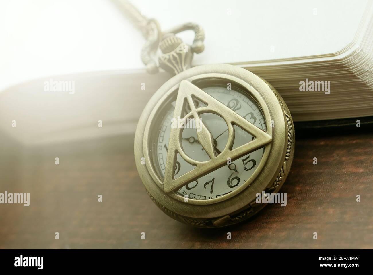 old antique classic clocks with a book on table  Stock Photo