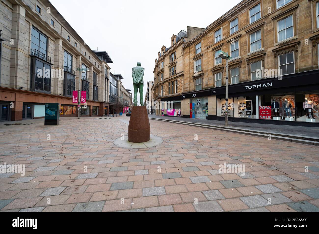 Glasgow, Scotland, UK. 26 March, 2020. Views from city centre in Glasgow on Thursday during the third day of the Government sanctioned Covid-19 lockdown. The city is largely deserted. Only food and convenience stores open. Pictured; Empty streets around statue of Donald Dewar on on Buchanan Street. Iain Masterton/Alamy Live News Stock Photo