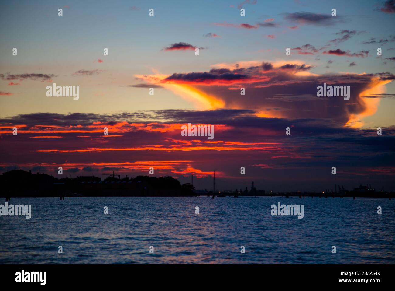 The sun sets as a storm approaches Venice, locked down and quarantined. Venice, Italy Stock Photo