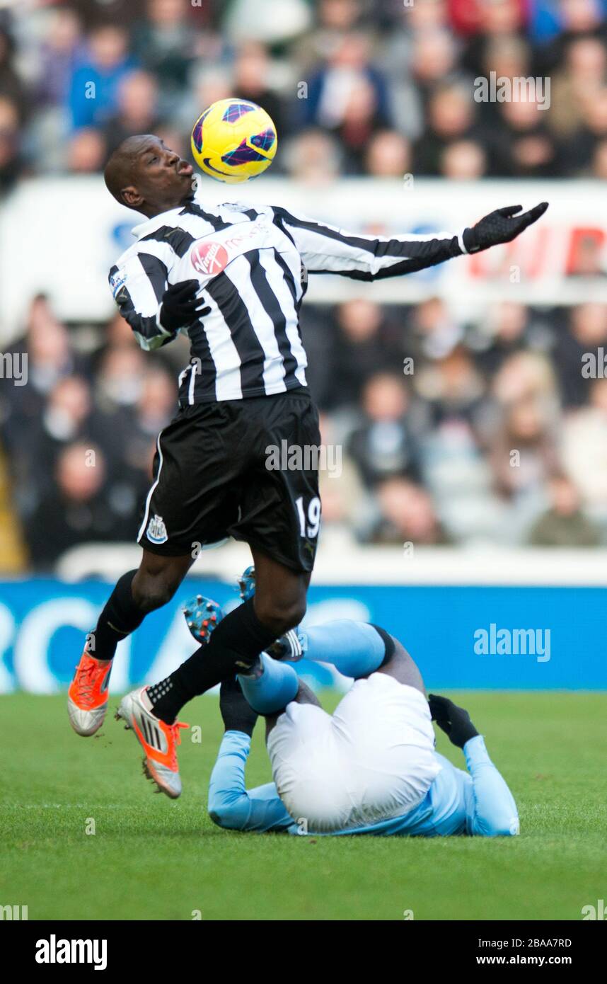 Newcastle United's Demba Ba clashes wtih Manchester City's Kolo Toure (floor) Stock Photo