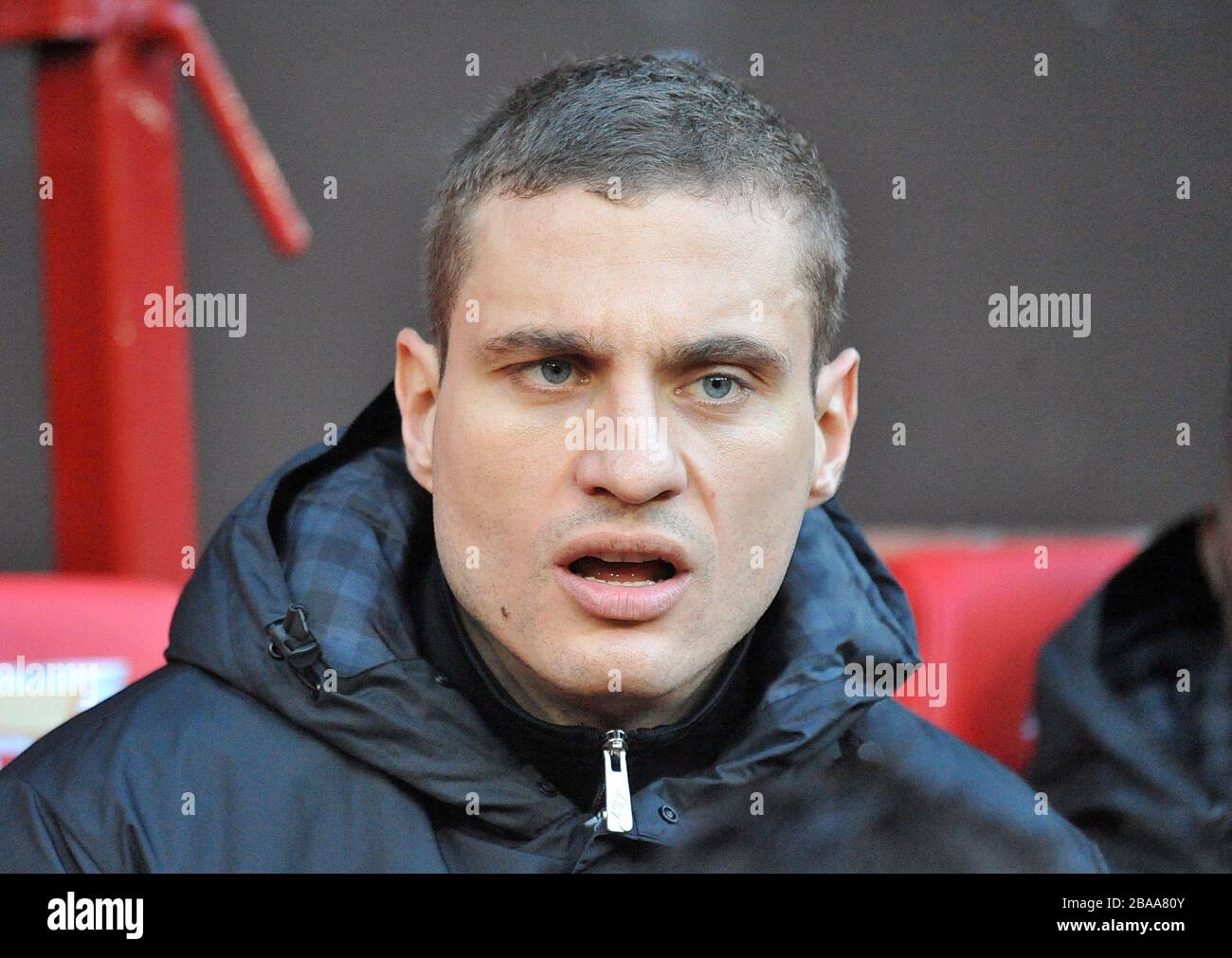 Manchester United's Nemanja Vidic on the substitutes bench before the game Stock Photo