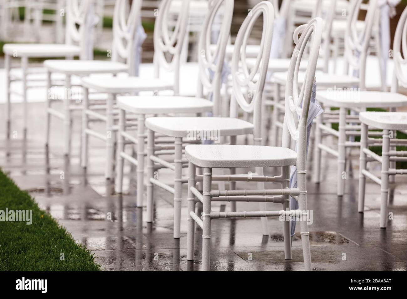 Rows of folding white chairs hi-res stock photography and images - Alamy