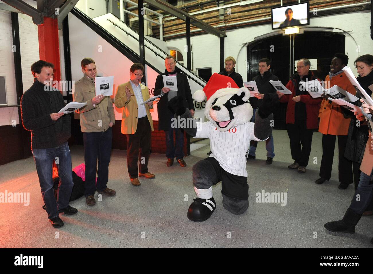 Billy the Badger conducts songs being sung by choir during Christmas at the Cottage Stock Photo