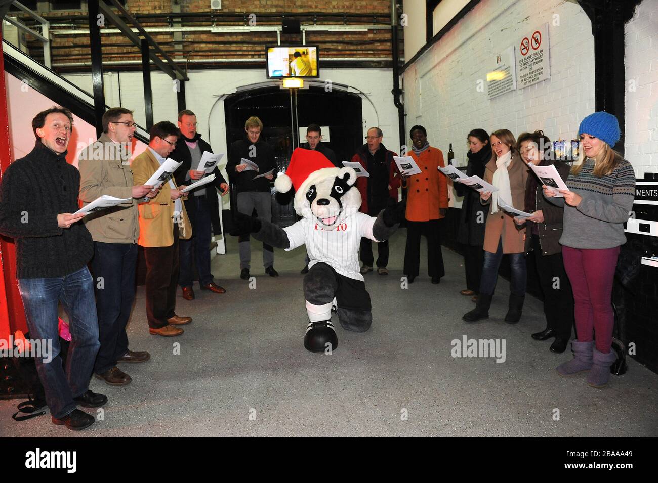 Billy the Badger conducts songs being sung by choir during Christmas at the Cottage Stock Photo