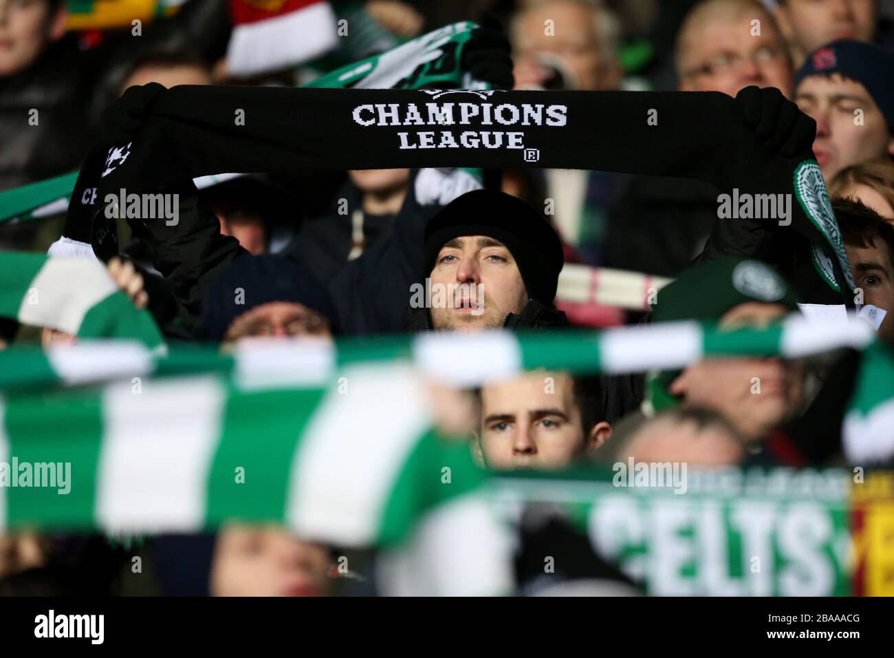 Celtic fans hold aloft their scarves Stock Photo