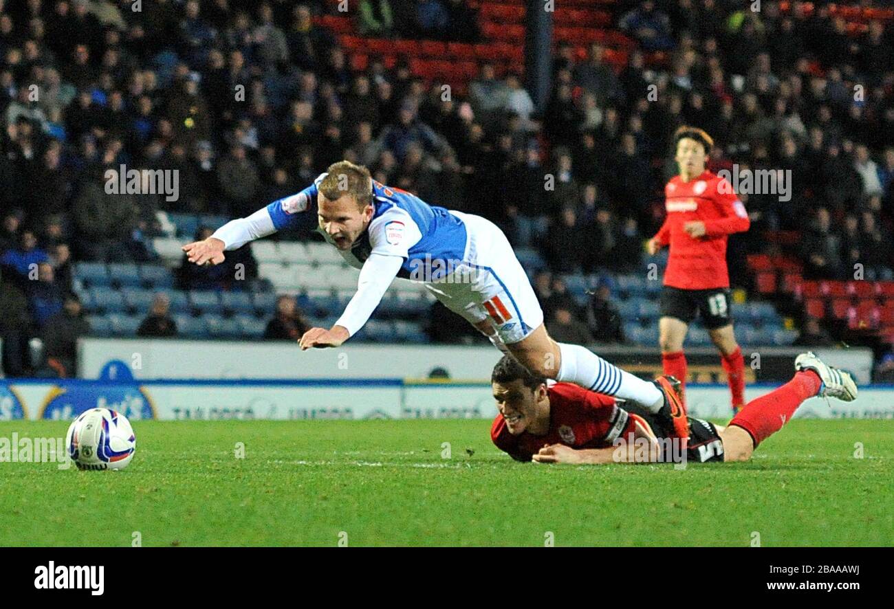 Blackburn Rovers' Jordan Rhodes (left) goes down under a challenge from Cardiff City's Mark Hudson but no foul is given Stock Photo
