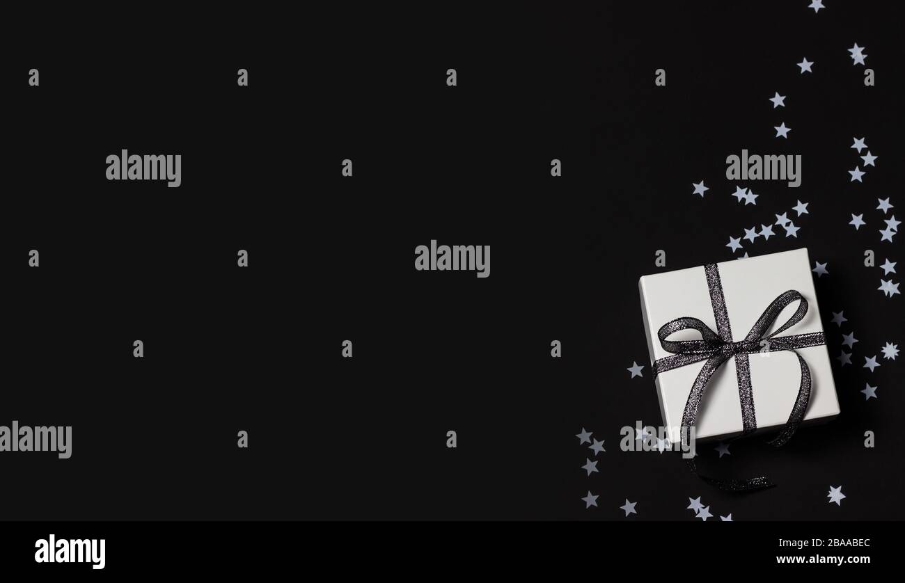 Festive wallpaper or backdrop with white confetti. Stock Photo
