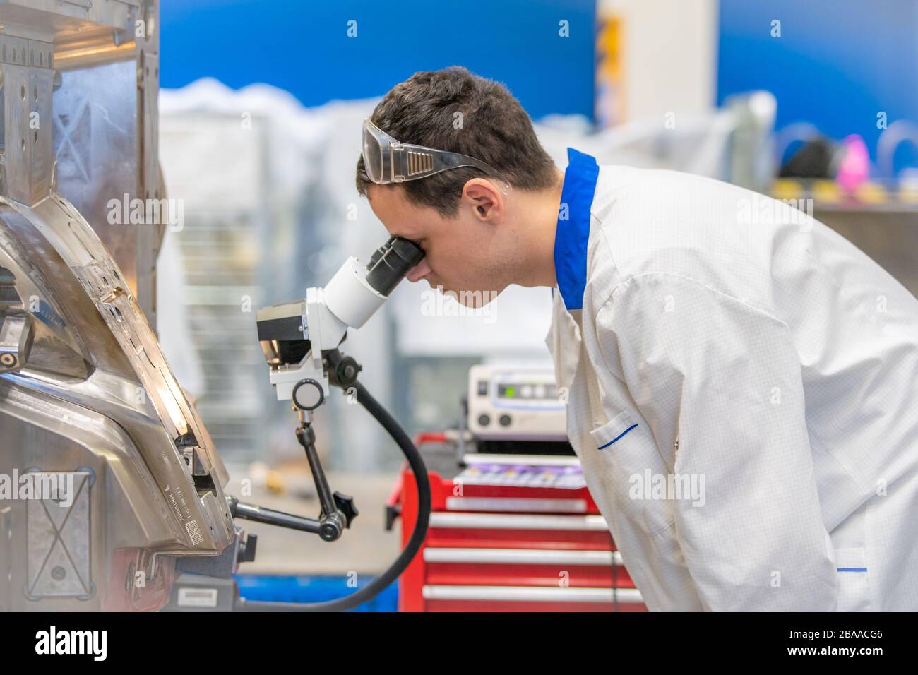 using a microscope while working in a research center Stock Photo