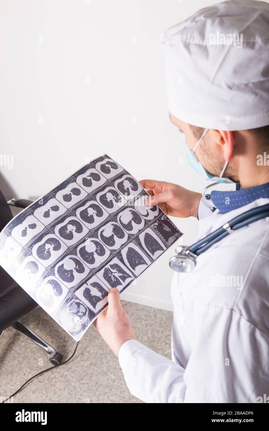 Doctor at appointment inspects and examines ct scan of chest and