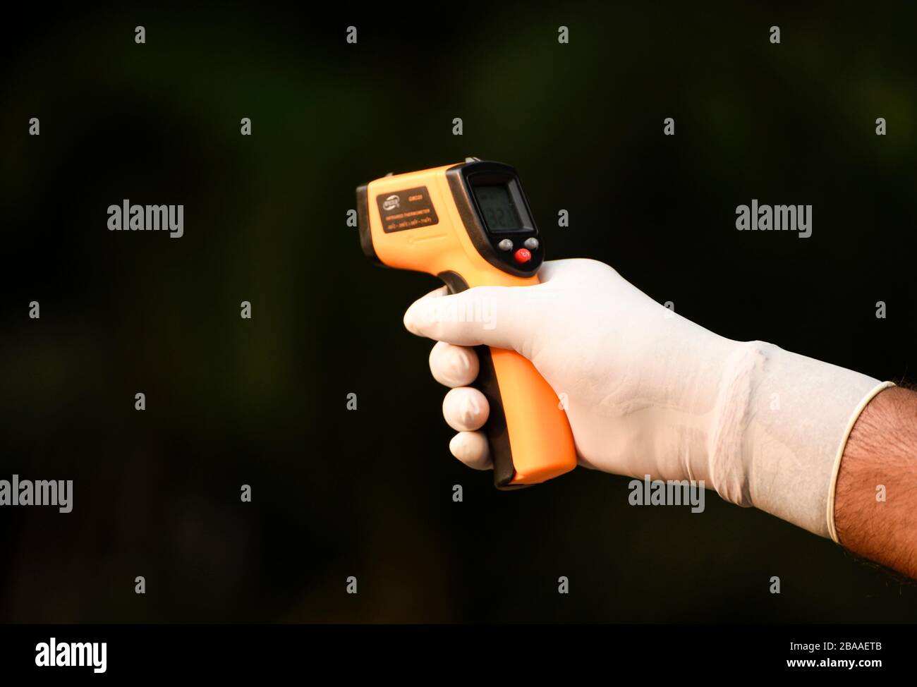 Guwahati, Assam, India. 26th Mar, 2020. Police personnel thermal screening a person before entering to Governor House to spray disinfectant, in Guwahati. Credit: David Talukdar/ZUMA Wire/Alamy Live News Stock Photo