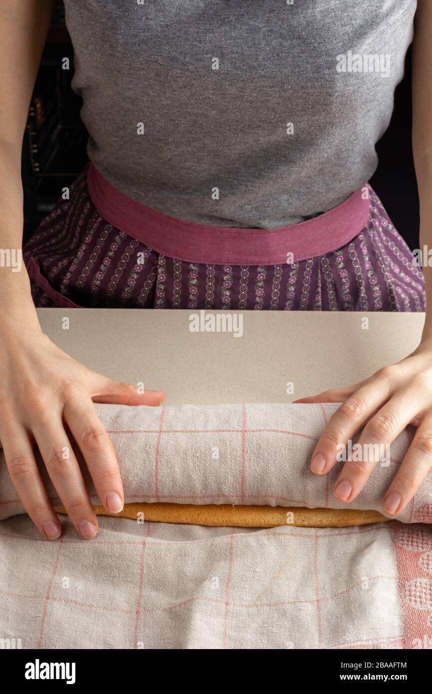 Preparation of a Swiss roll bending the warm sponge dough using a clean dish towel Stock Photo
