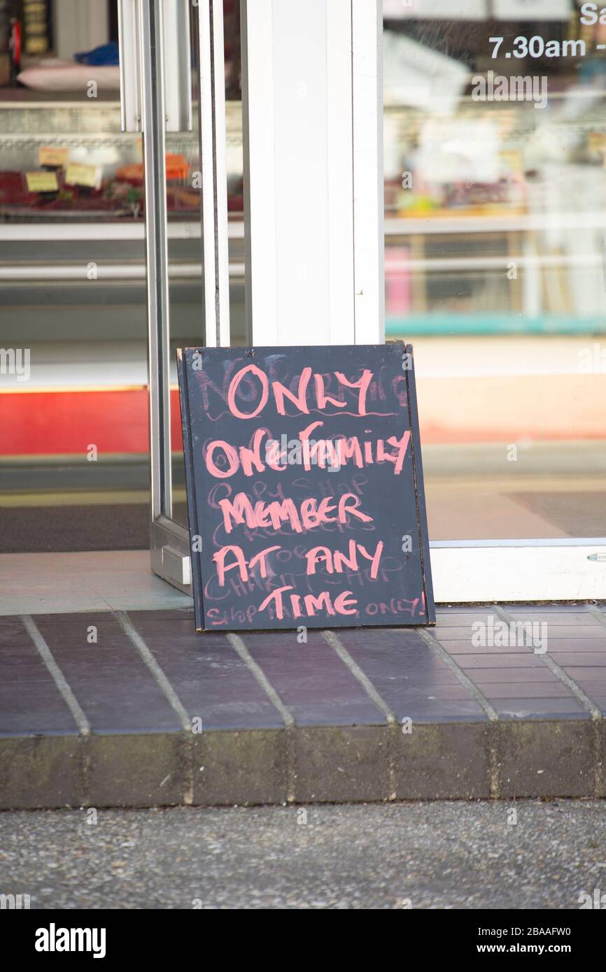 A sign outside a butchers shop in Gillingham Dorset indicating that only one family member is allowed in at any time due to the outbreak of the Corona Stock Photo
