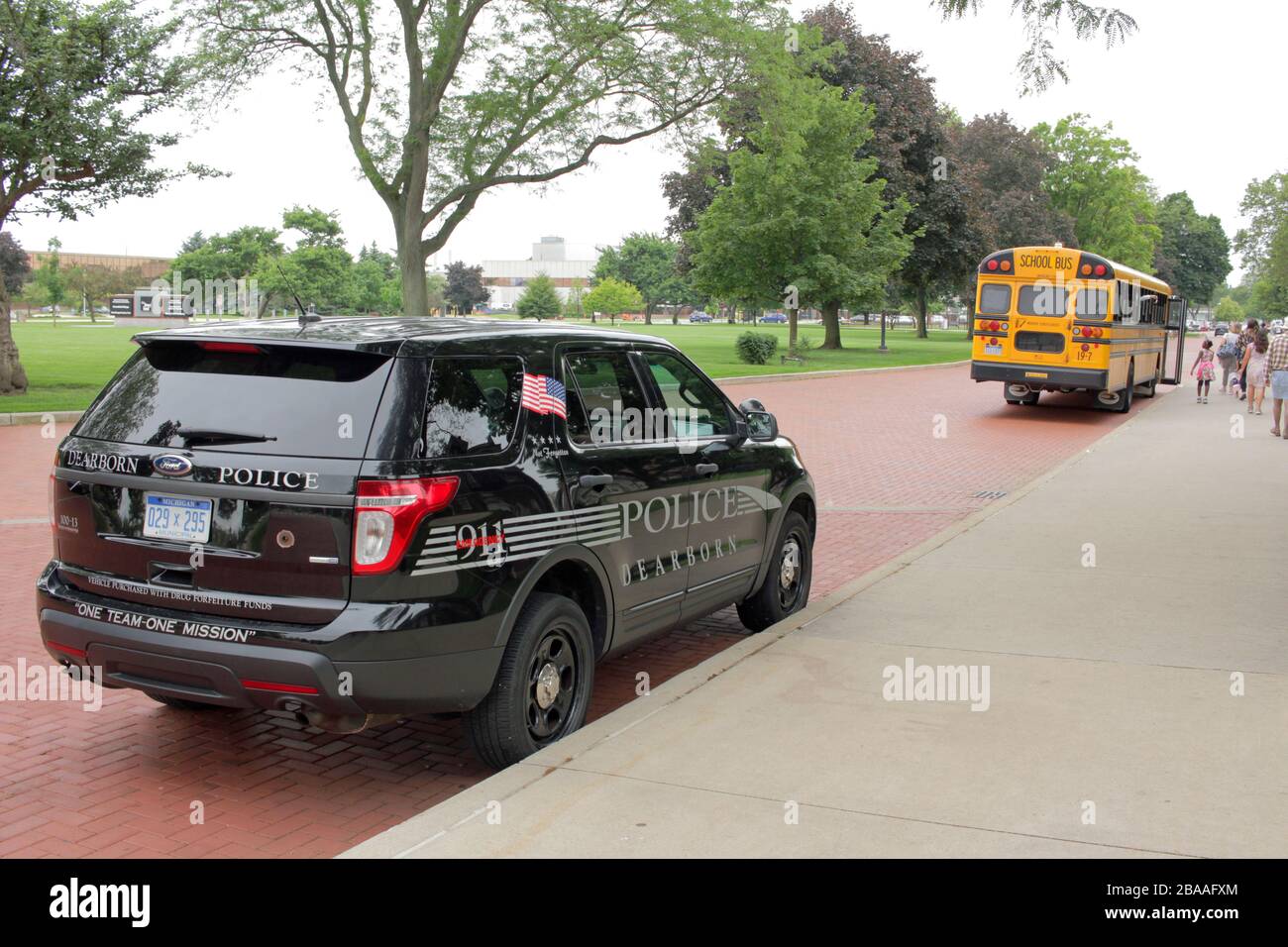 Dearborn Police Department vehicle and school bus outside the Henry Ford Museum, Dearborn, Michigan, USA Stock Photo