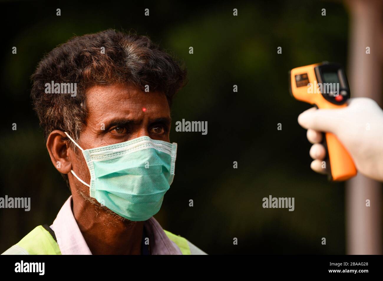 Guwahati, Assam, India. 26th Mar, 2020. Corona Virus emergency in Assam. Guwahati, Assam, India. 26th Mar, 2020. Police personnel thermal screening before entering to the Governor House of Assam, in Guwahati on 26 March, 2020. Credit: David Talukdar/Alamy Live News Credit: David Talukdar/Alamy Live News Stock Photo