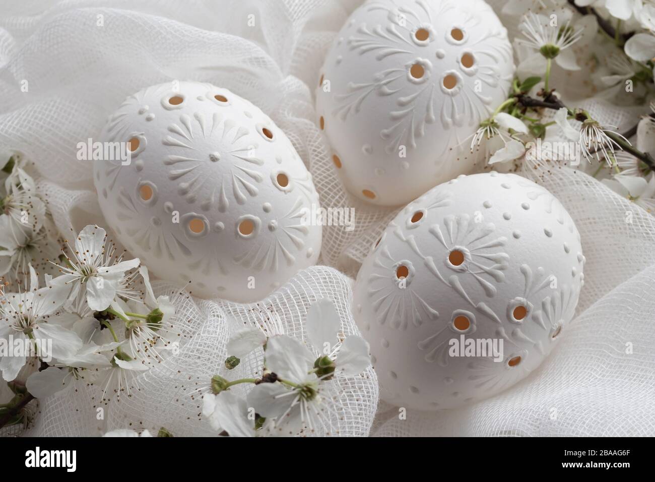 Three white Easter eggs decorated with wax, close up Stock Photo