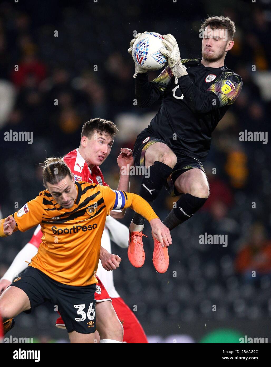 Barnsley goalkeeper Brad Collins catches the ball whilst under pressure Stock Photo