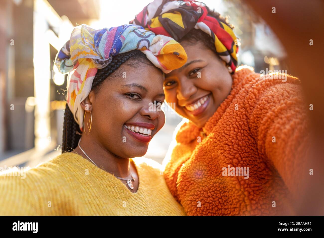Two beautiful Afro american women in an urban city area Stock Photo