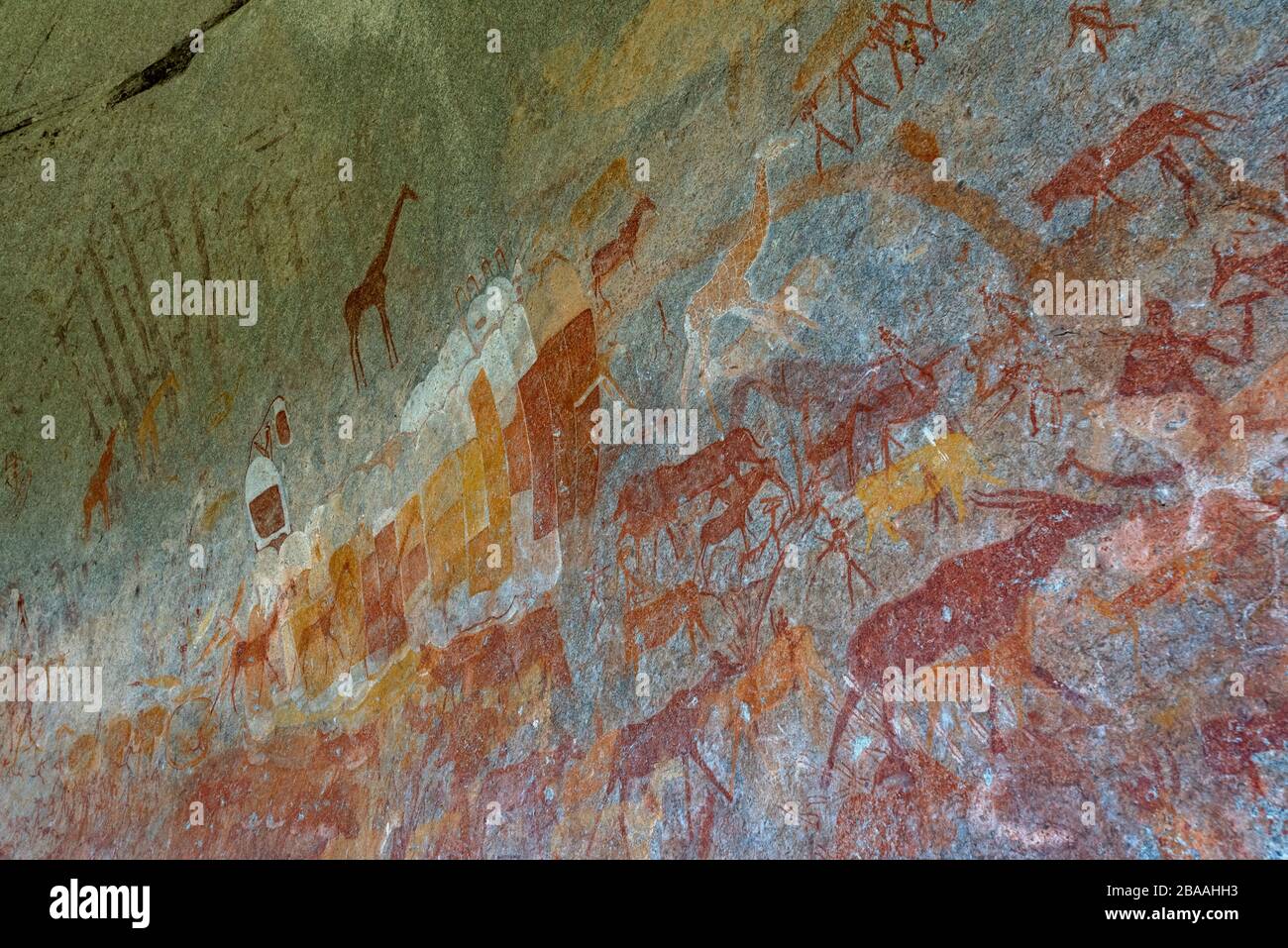 A tourist admires the San rock art in Inanke cave, Matobo National Park, Zimbabwe. Stock Photo