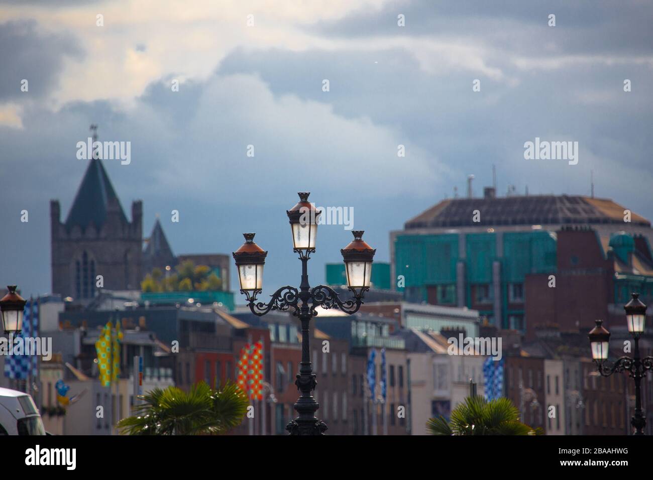 The city of Dublin set behind a Victorian triple lamp post. Stock Photo