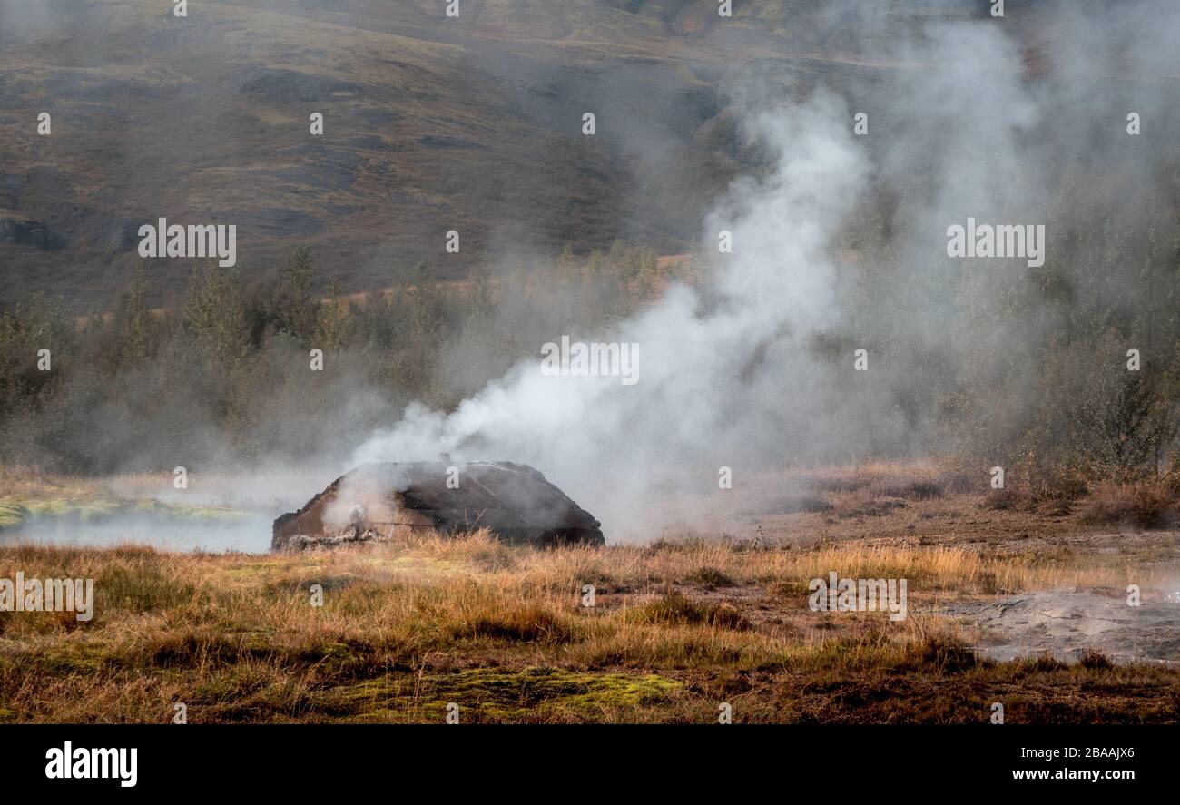 Wooden house burning down with smoke and mountains Stock Photo Alamy