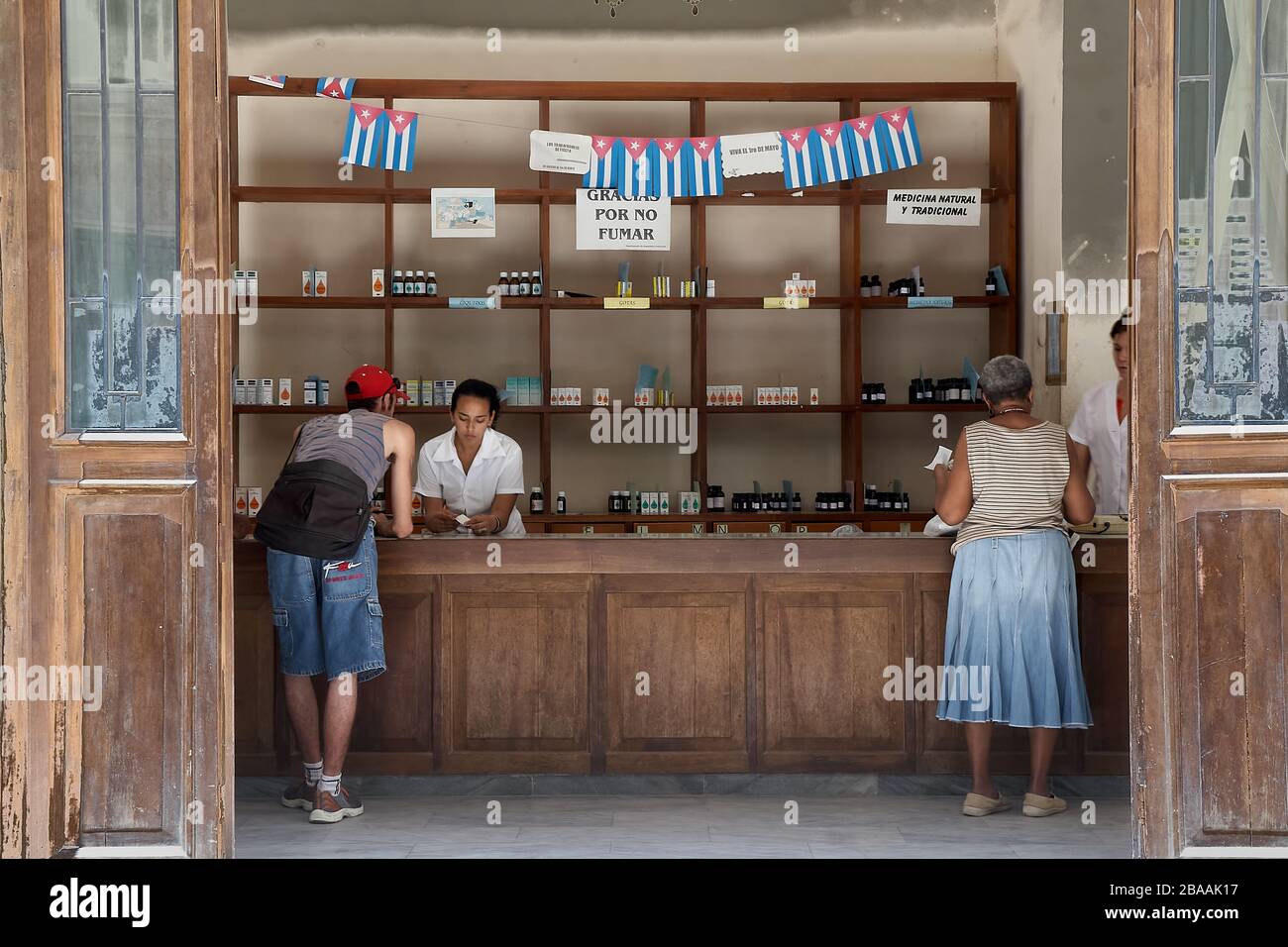 Cuban customers buying medicines in a pharmacy store selling