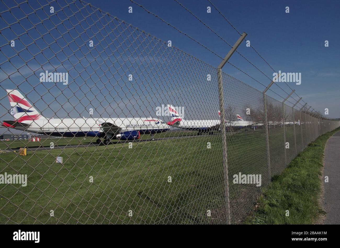 British Airways has parked rows of short-haul aircraft at Hurn Airport Bournemouth 26th March 2020. With less demand due to Covid 19 these short  haul British Airways planes are being parked around the country where there is space. Stock Photo