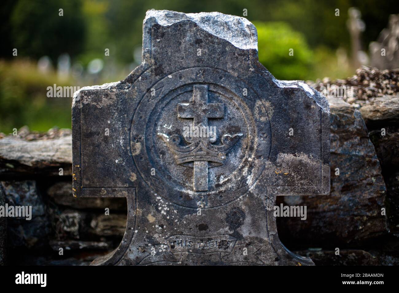 A tombstone in the shape of cross in an ancient cemetery in the Republic of Ireland, Ireland Stock Photo