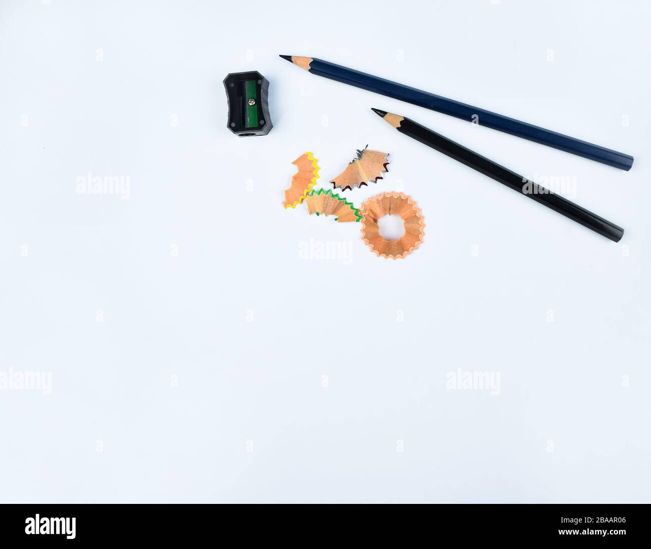 Study materials containing a black pencil and a Black pencil sharpener on a  white background Stock Photo - Alamy