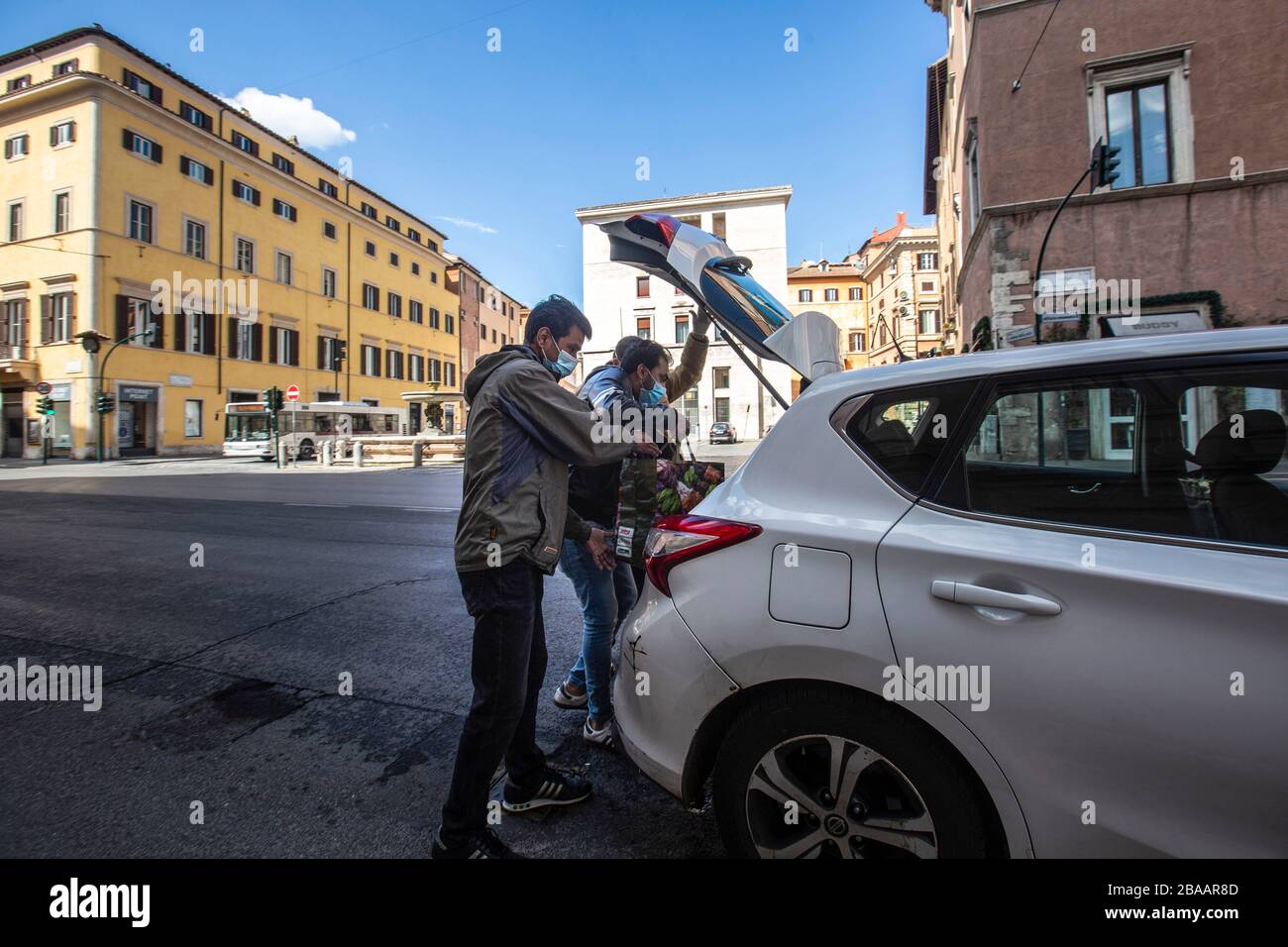 Rome March 25th 2020 Rome during the Coronavirus pandemic. customers take a taxi wears protettive masks in Corso Vittorio Emanuele  Photo by Elio Castoria Stock Photo