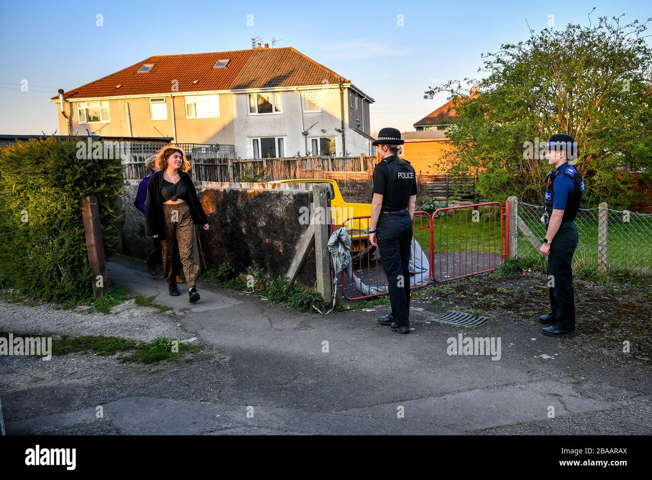 Avon and Somerset Police officers let people pass at a safe distance in Bristol, where they are patrolling and enforcing the coronavirus lockdown rules. Stock Photo