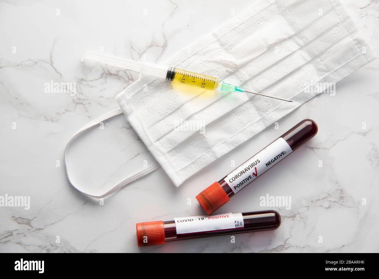 coronavirus covid-19 vaccine with blood sample and protection medical mask Stock Photo