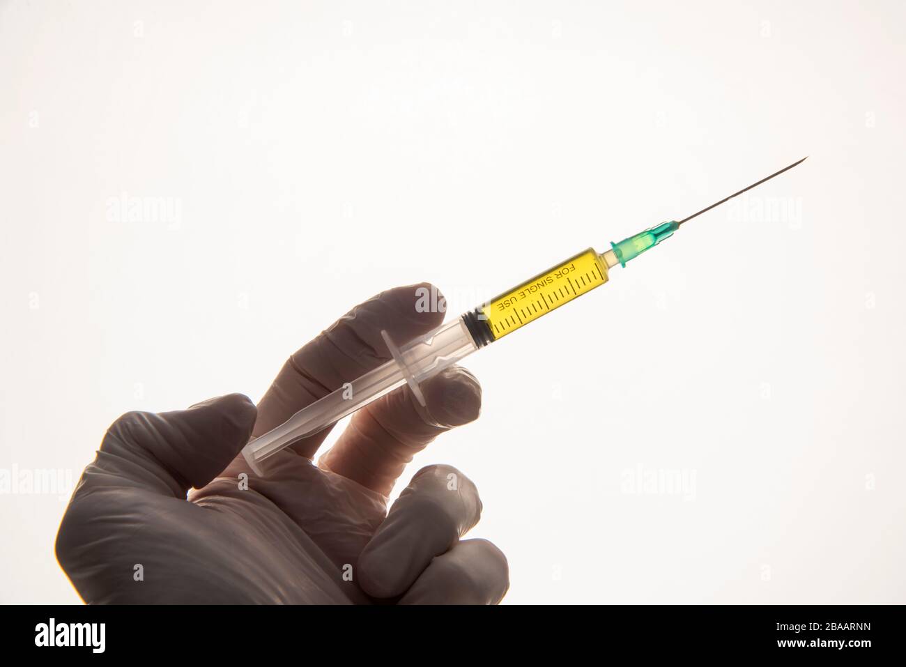 corona virus vaccine syringe on hand with blood sample Stock Photo