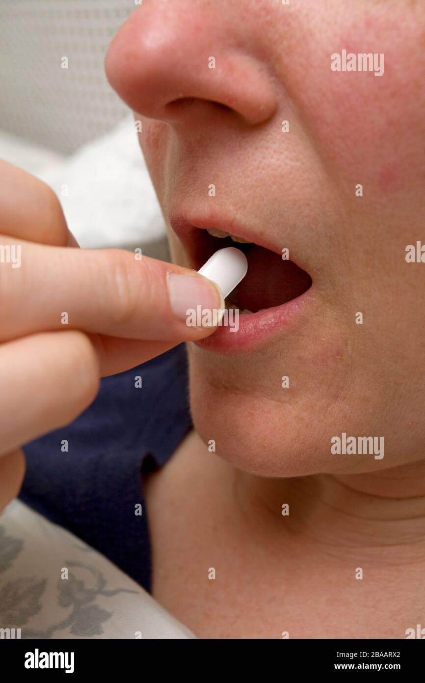 woman taking a paracetamol tablet Stock Photo