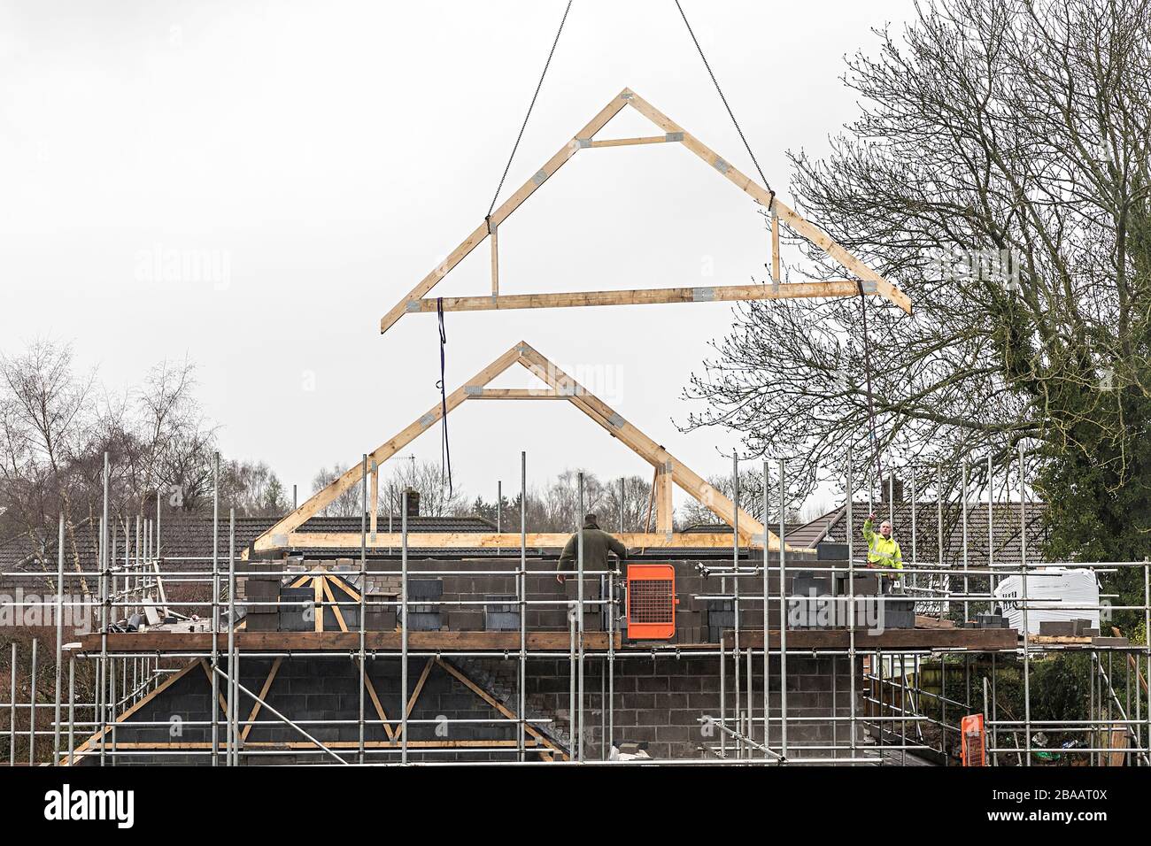 Lowering roof trusses while building new houses, Llanfoist, Wales, UK Stock Photo