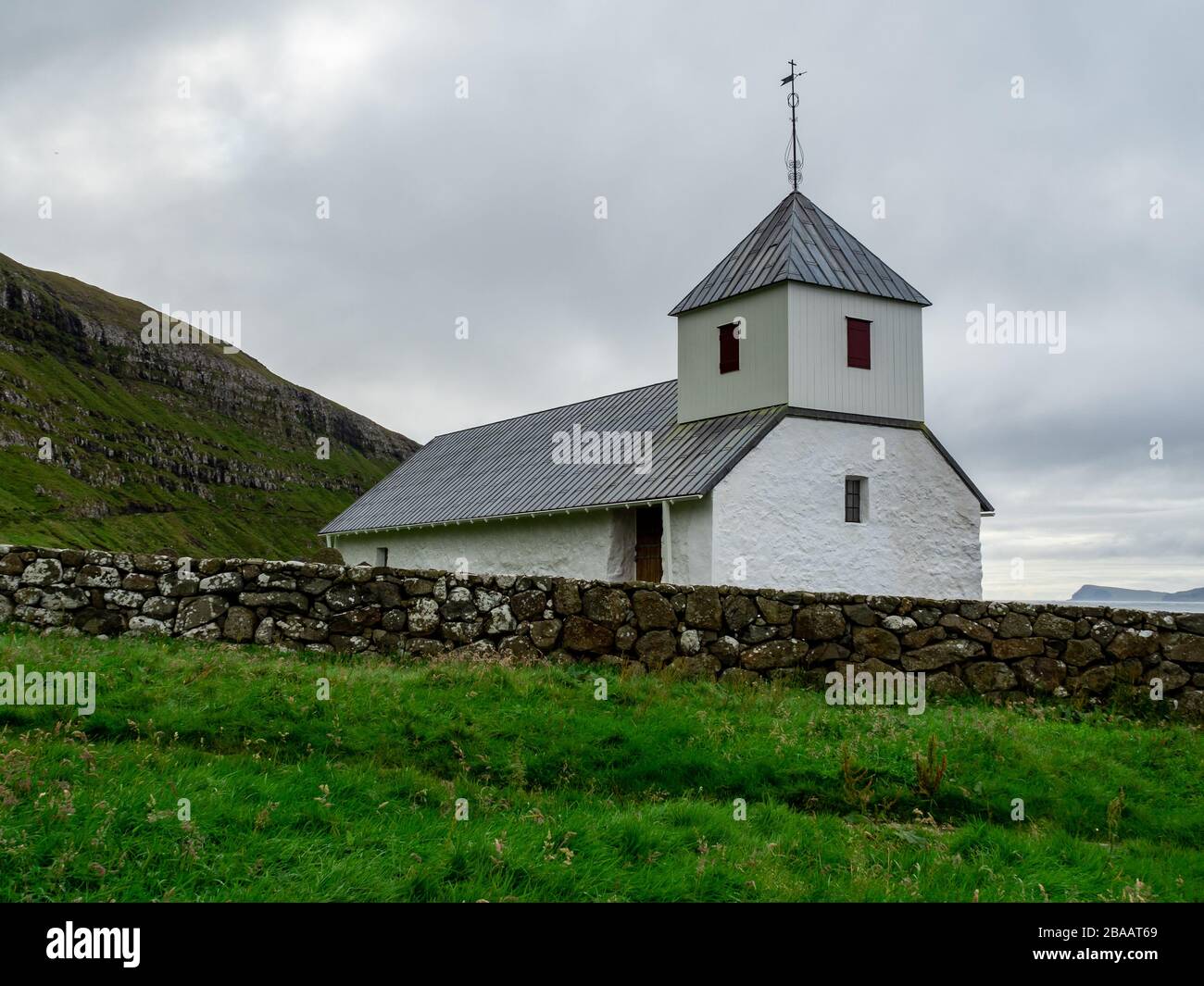 Faroe Islands. Kirkjubøur. Old and white church. Stock Photo