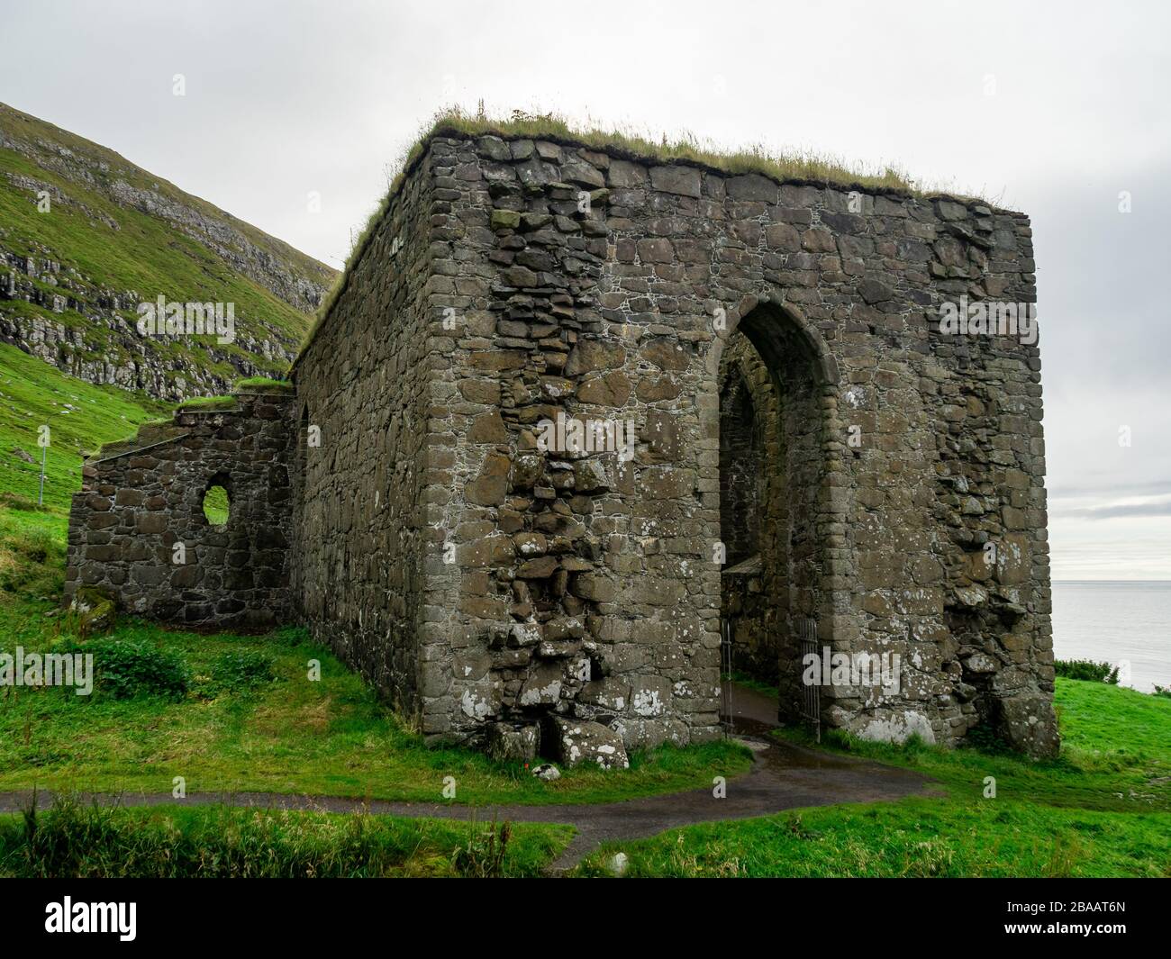 Faroe Islands. Kirkjubøur village. Old never roofed ruins of medieval cathedral. Stock Photo