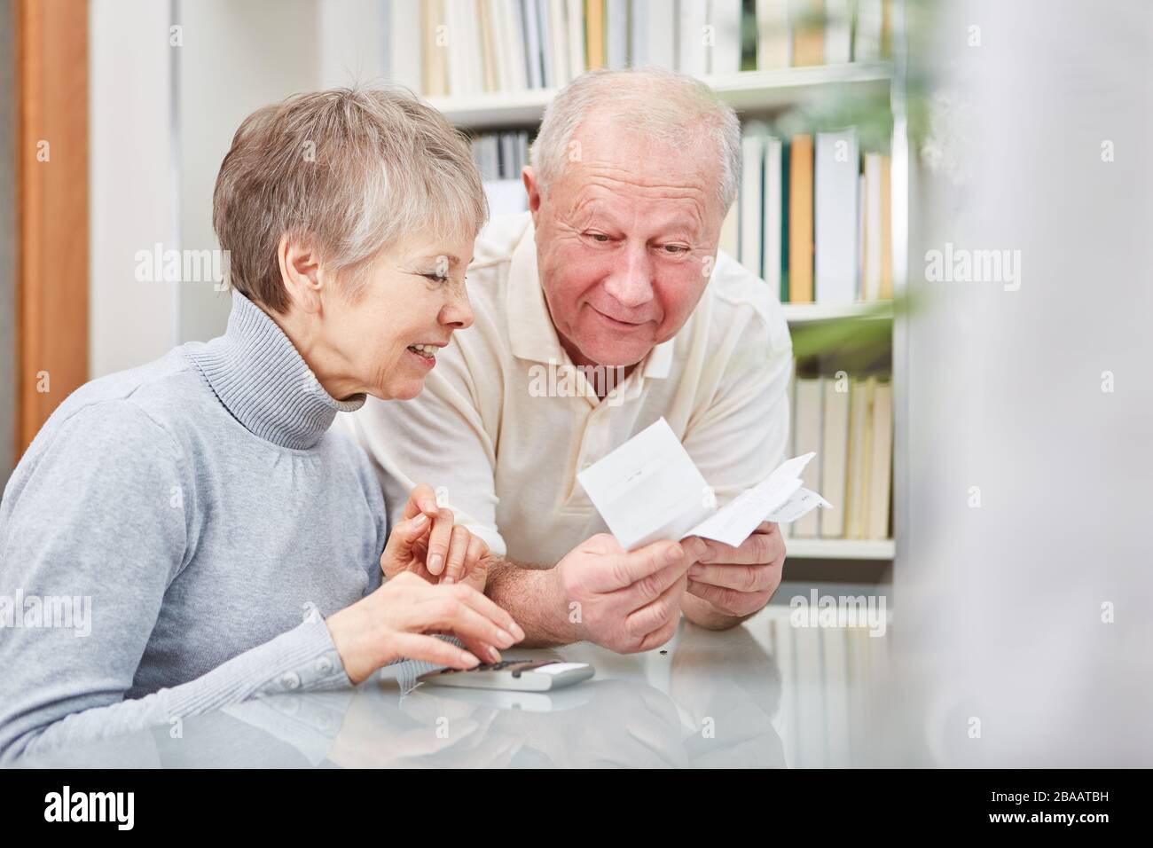 Couple of seniors with calculator and receipt do accounting Stock Photo