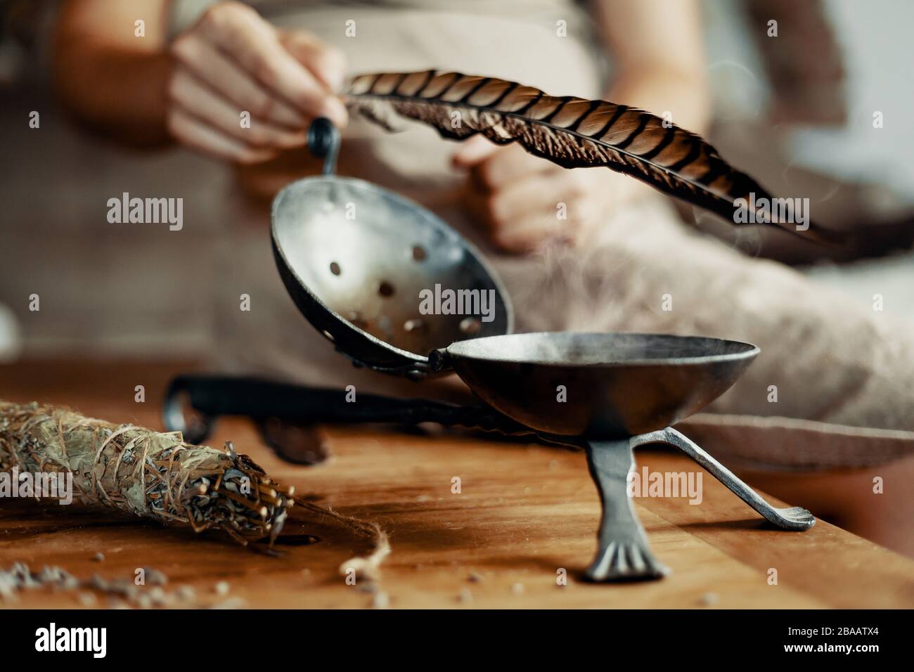 Woman with incense bowl and feather Stock Photo