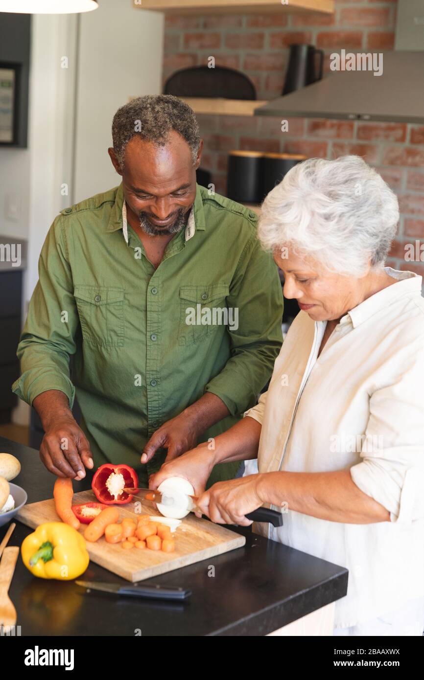 Senior African American couple cooking in kitchen Stock Photo - Alamy