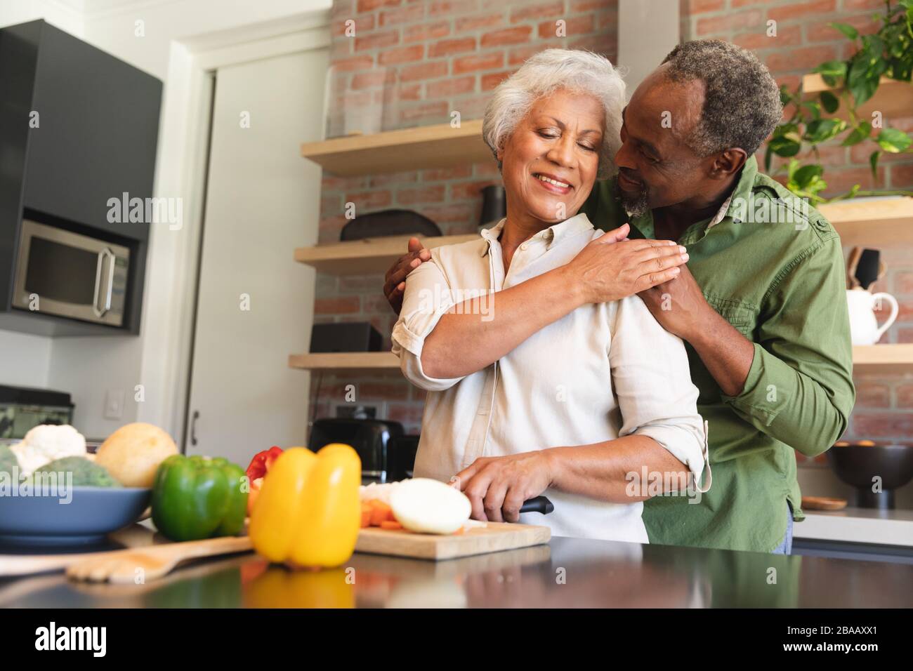 Senior African American couple cooking in kitchen Stock Photo - Alamy