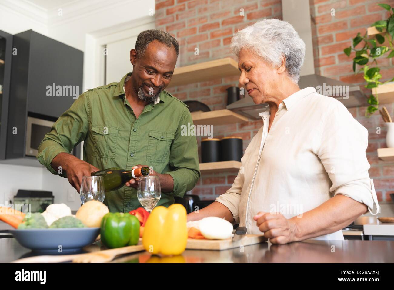 Senior African American couple cooking in kitchen Stock Photo - Alamy