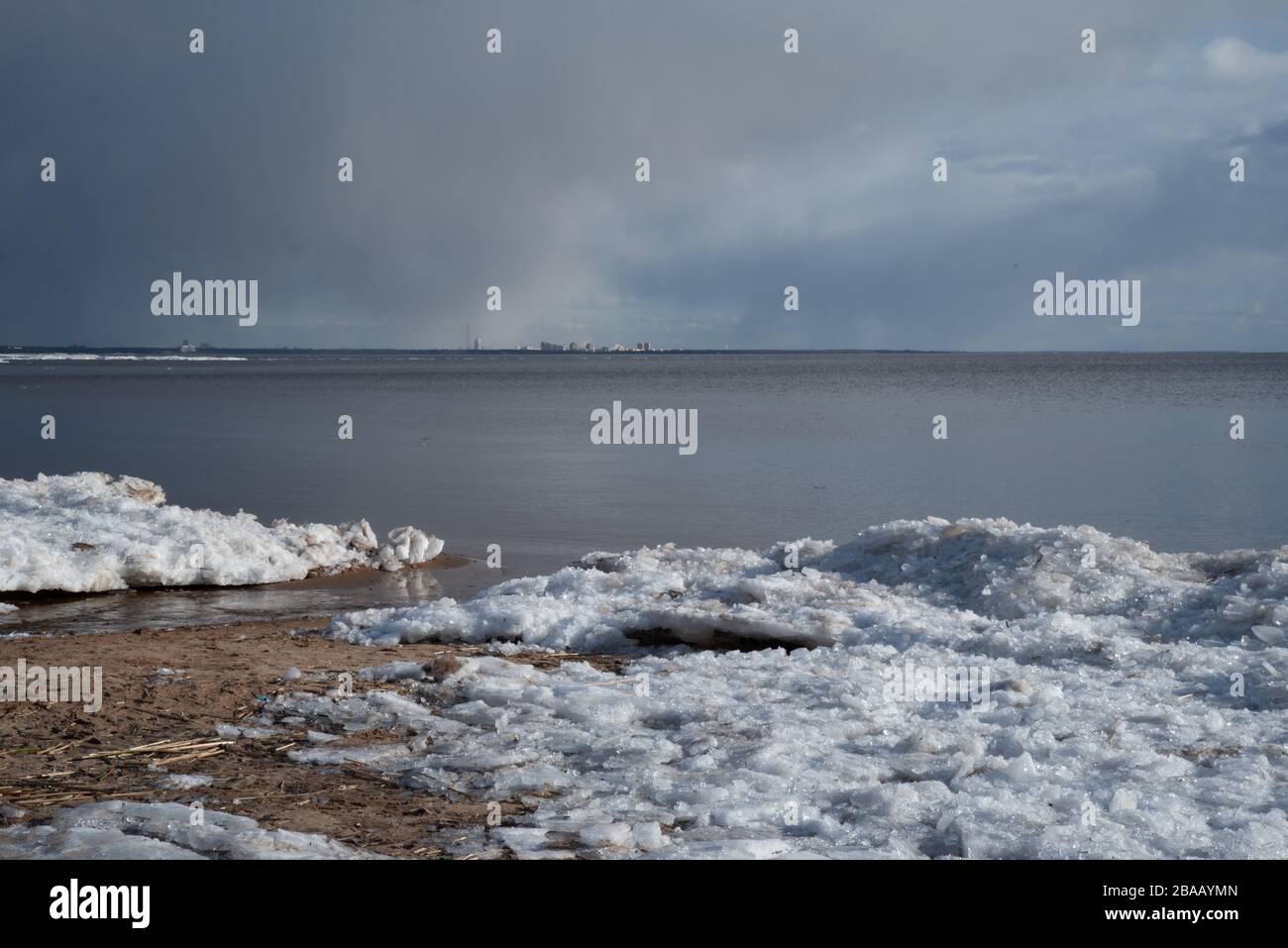 Ice hummocks on the shore of the Gulf of Finland in early spring, St. Petersburg in the background, Seaside Park Komarovo, Russia Stock Photo