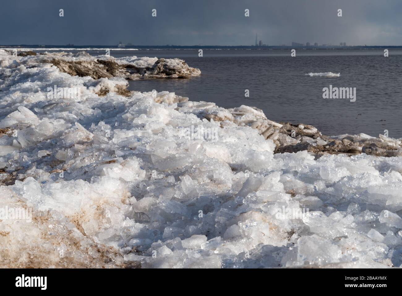 Ice hummocks on the shore of the Gulf of Finland in early spring, St. Petersburg in the background, Seaside Park Komarovo, Russia Stock Photo