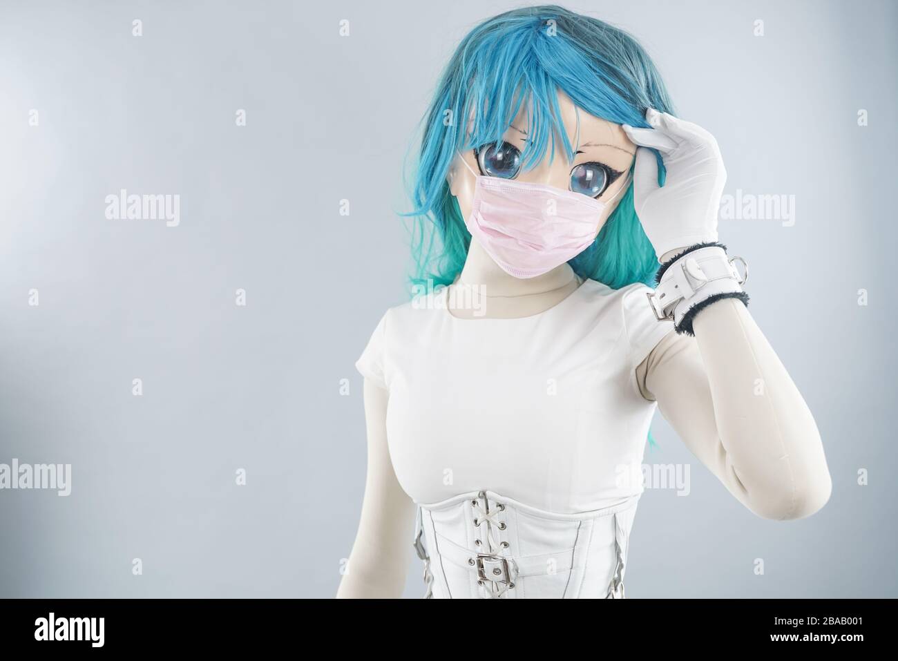 alternative cosplayer stay at home and wearing pink medical mask on white studio background