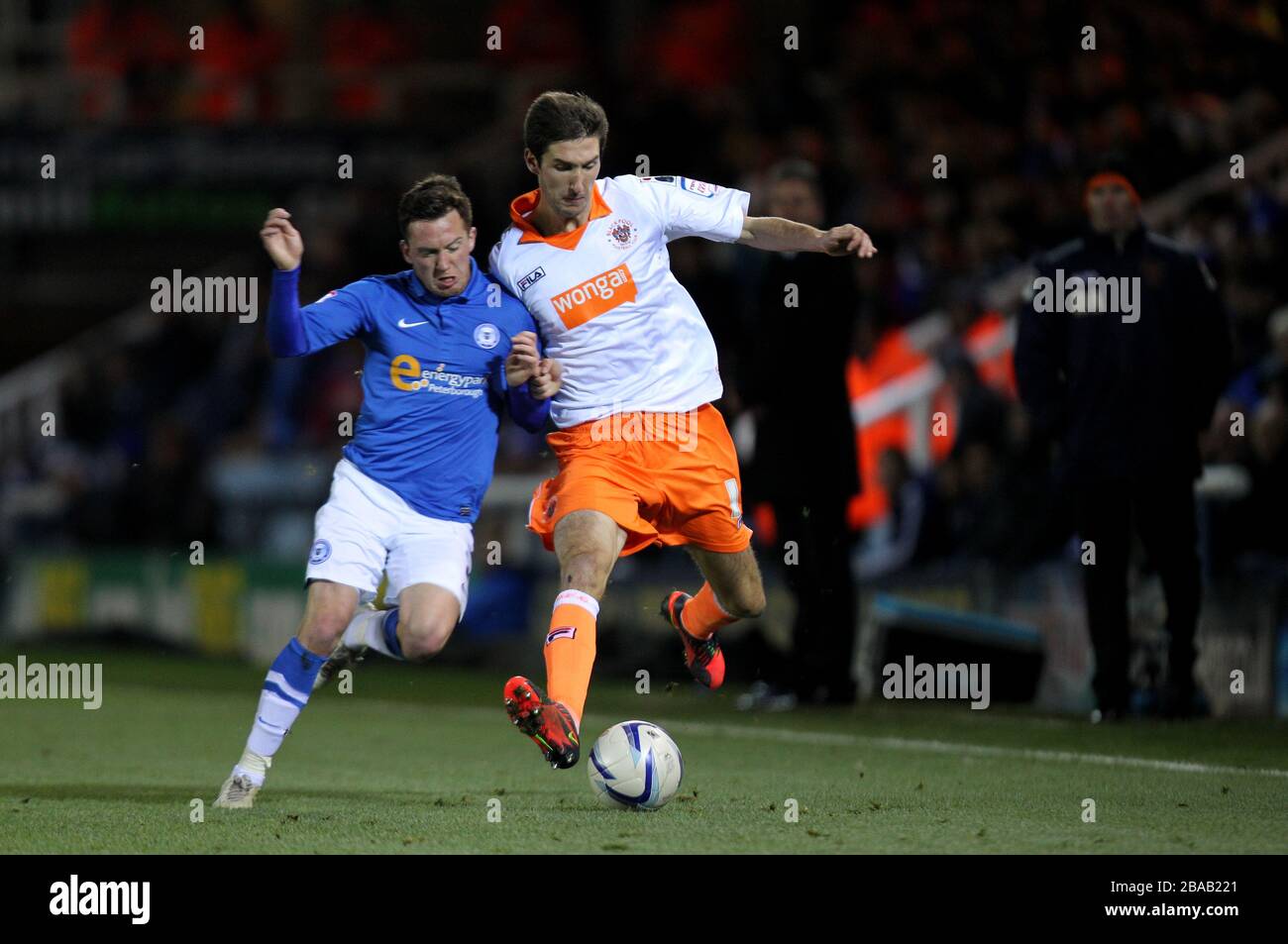 Peterborough United's Danny Swanson challenges  Blackpool's Chris Basham Stock Photo