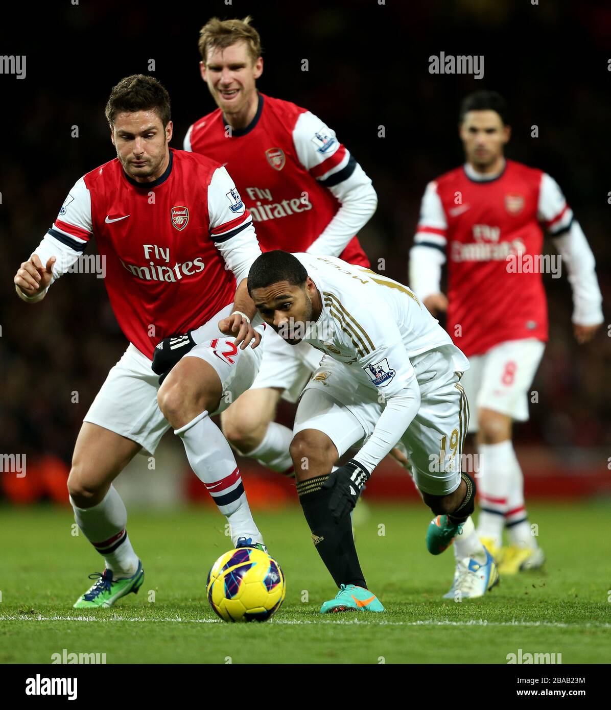 Swansea City's Luke Moore fights for the ball with Arsenal's Olivier Giroud Stock Photo