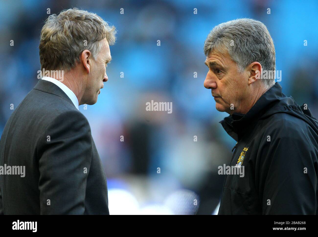 Everton manager David Moyes (left) speaks with Manchester City assistant manager Brian Kidd before the gamea Stock Photo
